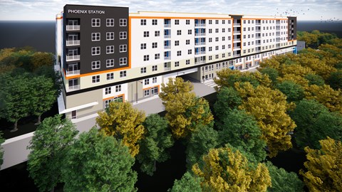 an aerial view of a tall apartment building with trees